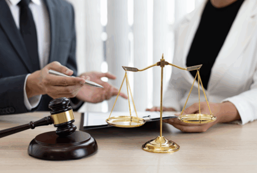 Image is of two attorneys discussing a client's case, concept of filing a wrongful death claim after the loss of a loved one following a fatal accident.