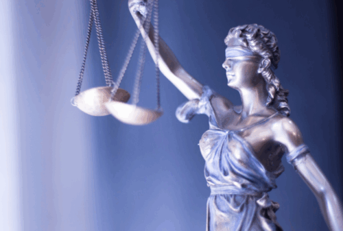 Image is of a closeup of a blindfolded lady justice holding the scales of justice, concept of underride accidents in Nashville