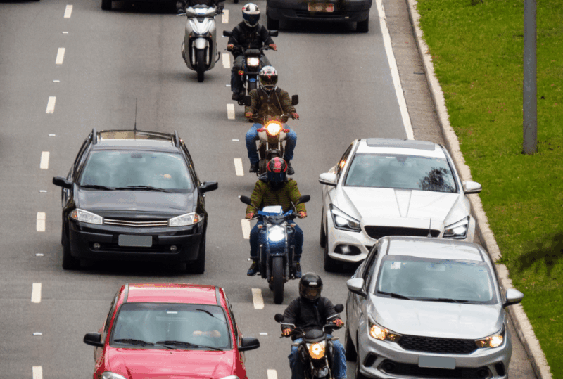 Image is of a line of motorcycle riders lane splitting in traffic, concept of lane splitting laws in Nashville
