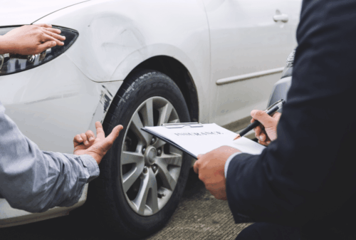 Image is of a car owner showing car damage to car insurance claims adjuster, concept of how to handle a hit-and-run accident in Nashville