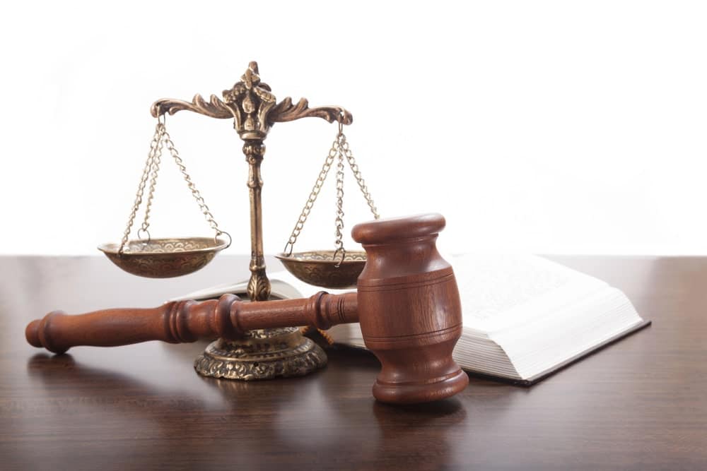 Wooden gavel and justice scales symbolizing legal help after a serious accident