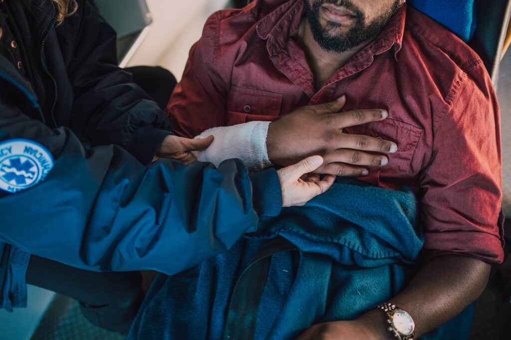 Paramedic helping an injured man after a truck accident in Nashville.