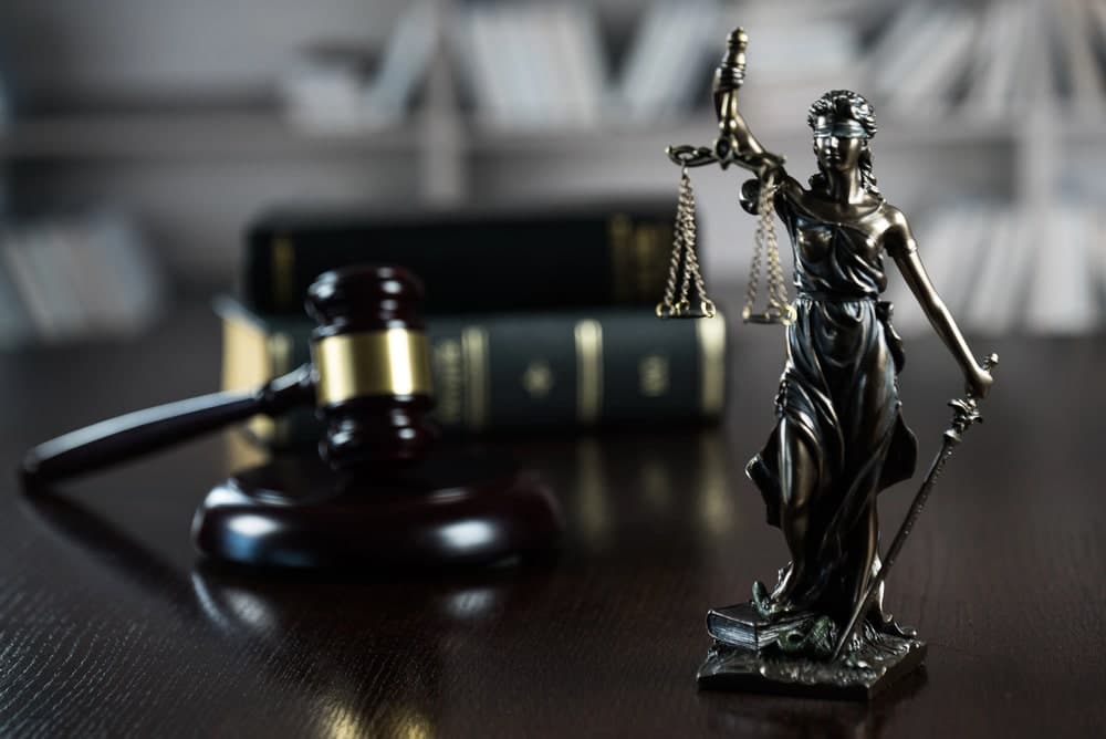 Lady Justice statue and gavel symbolizing legal support after a truck crash.