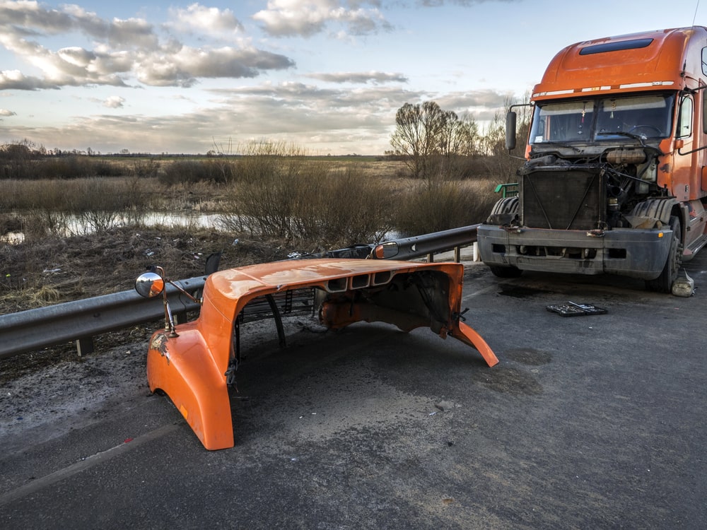 Image shows a heavily damaged commercial truck with its front panel removed, illustrating the aftermath often associated with truck accident injuries.