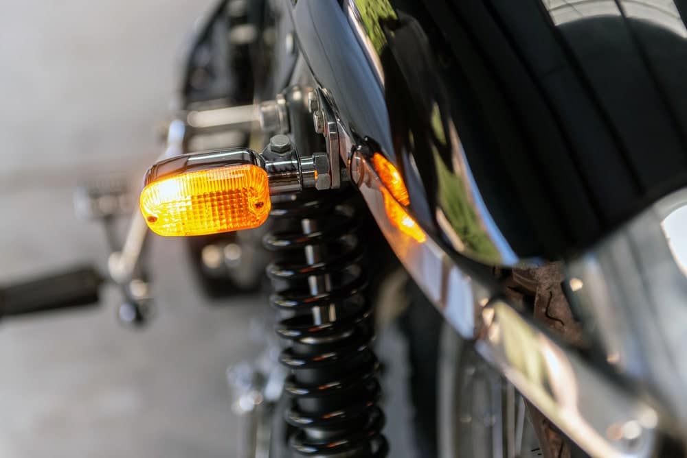 Image is of a motorcycle rear turn signal and suspension system, emphasizing visibility and mechanical factors involved in motorcycle accidents in Nashville
