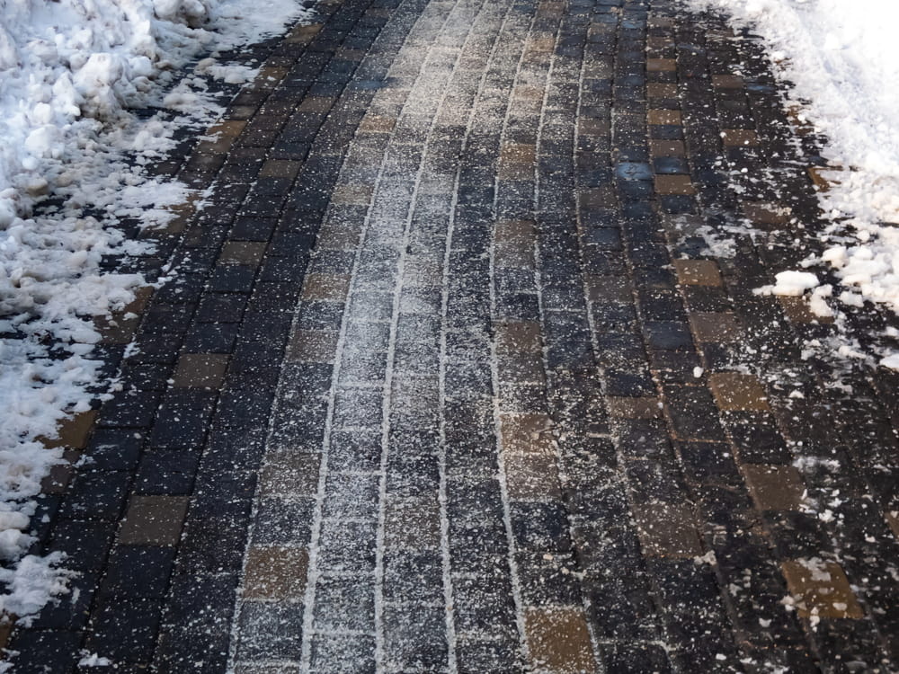 Image is of an icy pedestrian walkway after winter weather, illustrating dangerous conditions that commonly result in slip and fall claims.