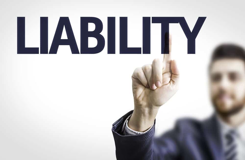 Image is of a person pointing to the word liability, representing how responsibility is determined in cases involving slip and fall injuries on public sidewalks.