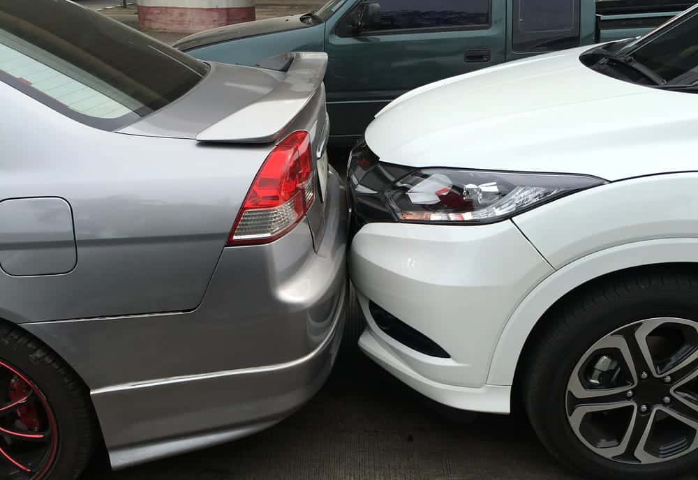Image is of two cars pressed bumper to bumper after a Nashville rear-end accident, concept of impact points and fault determination.