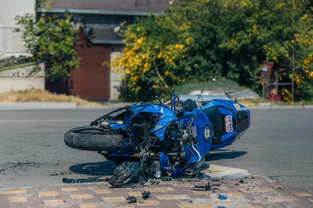 Image is of a damaged motorcycle lying on the road after a crash, illustrating real consequences of an accident in Nashville