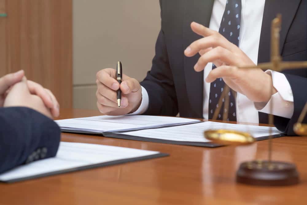 Image is of a lawyer reviewing documents with a client during a consultation, representing guidance from a Nashville motorcycle accident lawyer
