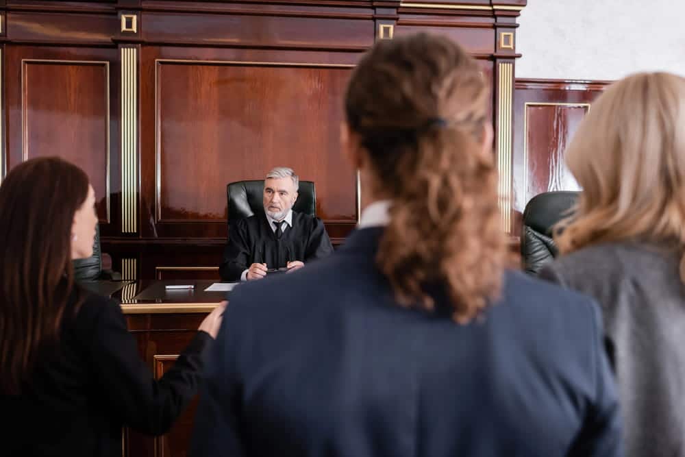 Image is of a judge addressing individuals inside a courtroom, concept of a car accident court hearing and legal proceedings in Nashville.