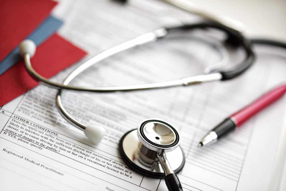 Image is of medical paperwork with a stethoscope resting on top, concept of medical evidence and injury documentation in a Nashville dog bite case.