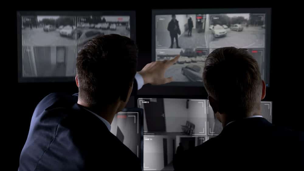 Image is of two people reviewing surveillance footage on multiple screens, concept of gathering evidence and liability analysis in Nashville slip and fall cases.