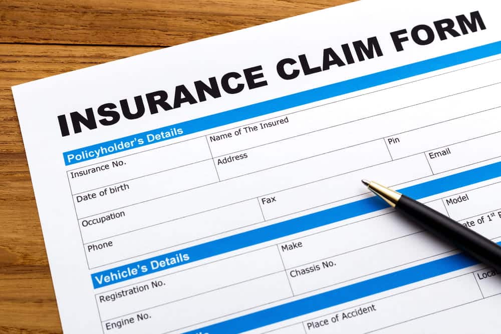 Image is of a vehicle insurance claim form with a pen placed beside it, concept of coverage options after a Nashville truck accident.