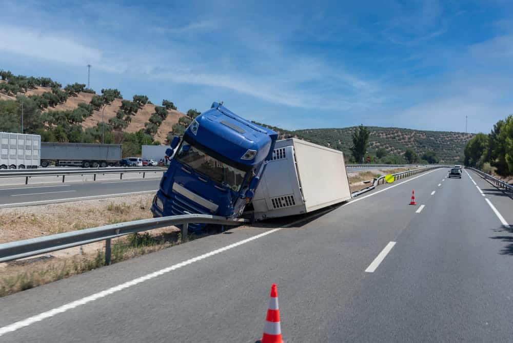 Image is of a commercial truck involved in a highway collision, concept of black box data helping determine fault in a Nashville truck accident case.