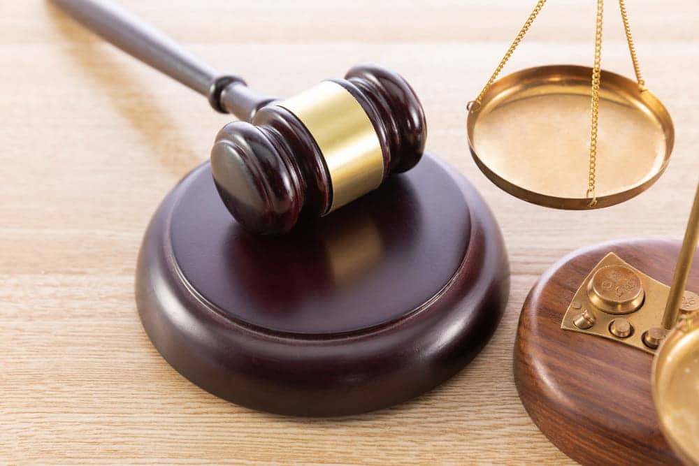 Image is of a judge's gavel and scales of justice, representing the legal process after a dog attack in Nashville.