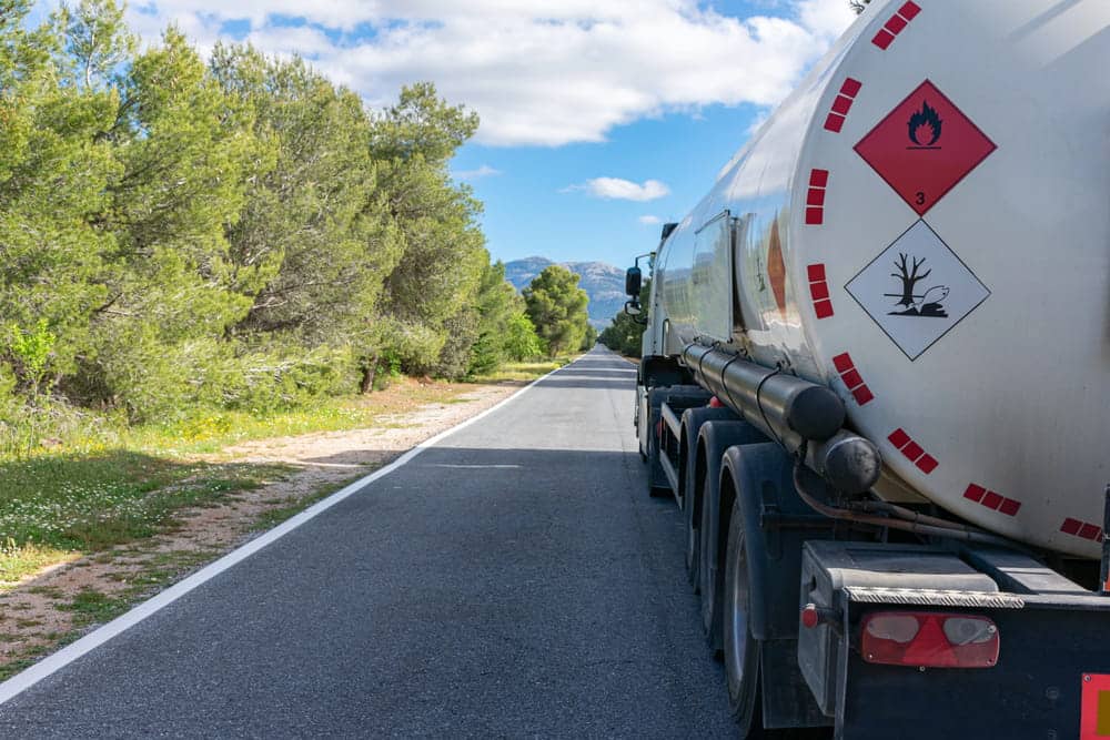 Image is of a tanker truck transporting hazardous materials on a roadway, concept of a truck crash in Nashville involving dangerous cargo.
