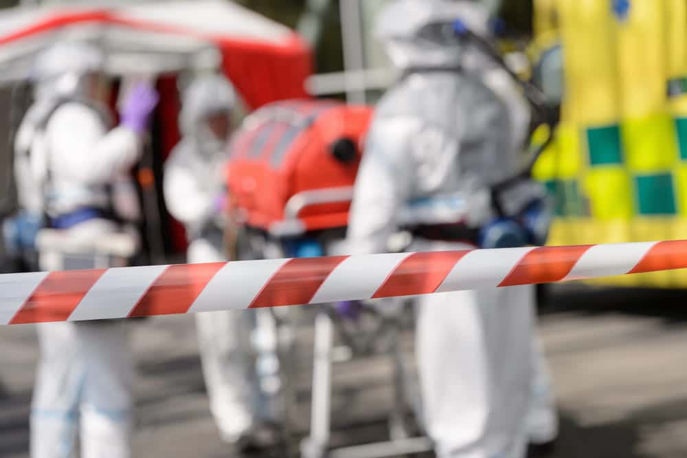 Image is of emergency responders in protective gear securing an incident scene, concept of a truck crash in Nashville involving hazardous materials.