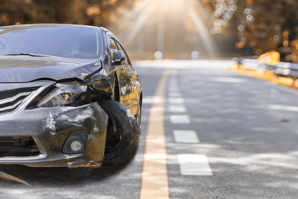 Image is of a damaged vehicle stopped along a roadway after a collision, concept of a car accident in Nashville and the steps drivers may need to take following a hit-and-run crash.