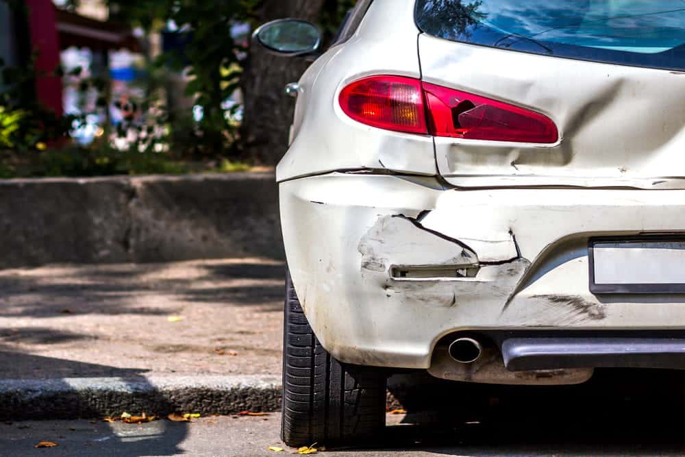 Image is of a vehicle with visible rear-end damage after a collision, concept of a car accident in Nashville involving property damage and potential hit-and-run investigations.