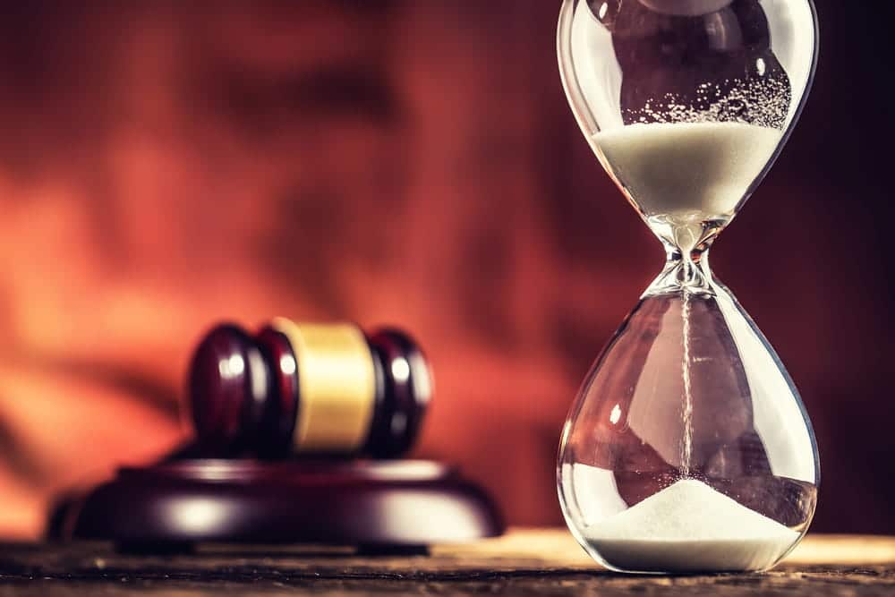Image is of an hourglass beside a gavel, concept of legal filing deadlines for a slip and fall claim in Tennessee