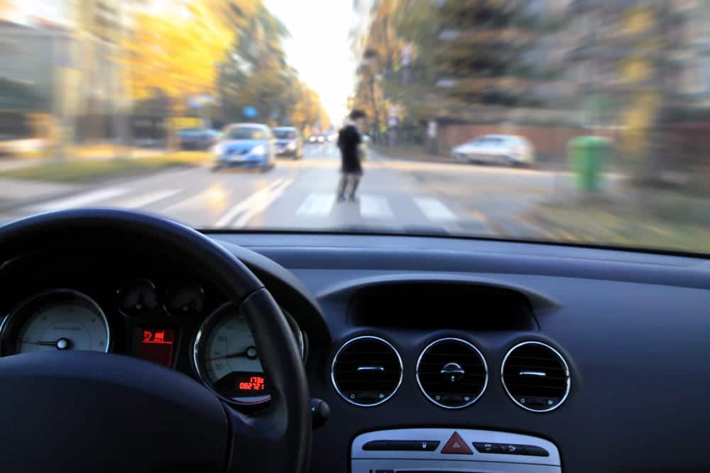 Image is of a person taking photographs of a crash scene after a rideshare car accident in Nashville, concept of preserving evidence for an insurance claim.