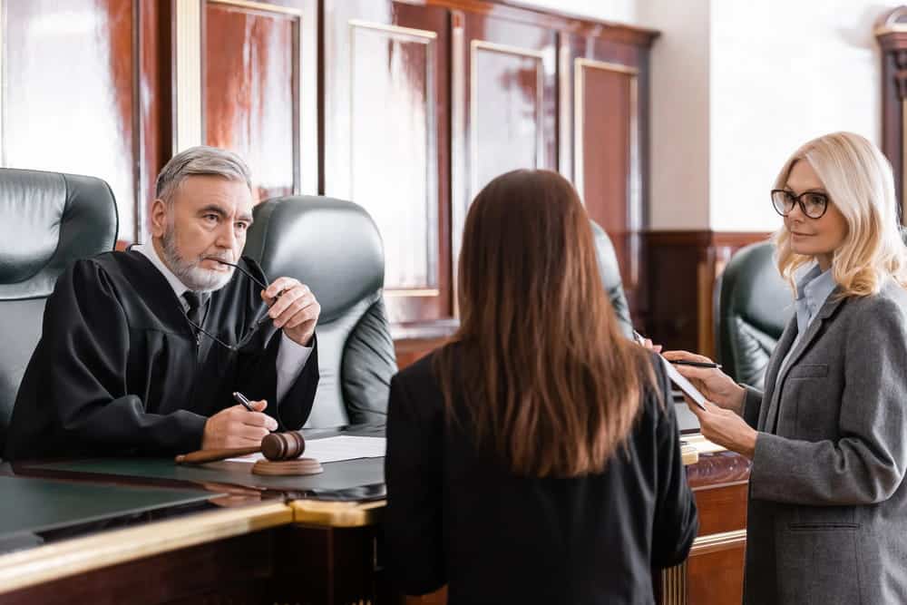 Image is of a judge speaking with attorneys during a courtroom hearing, concept of a truck accident lawsuit in Nashville and the court process.