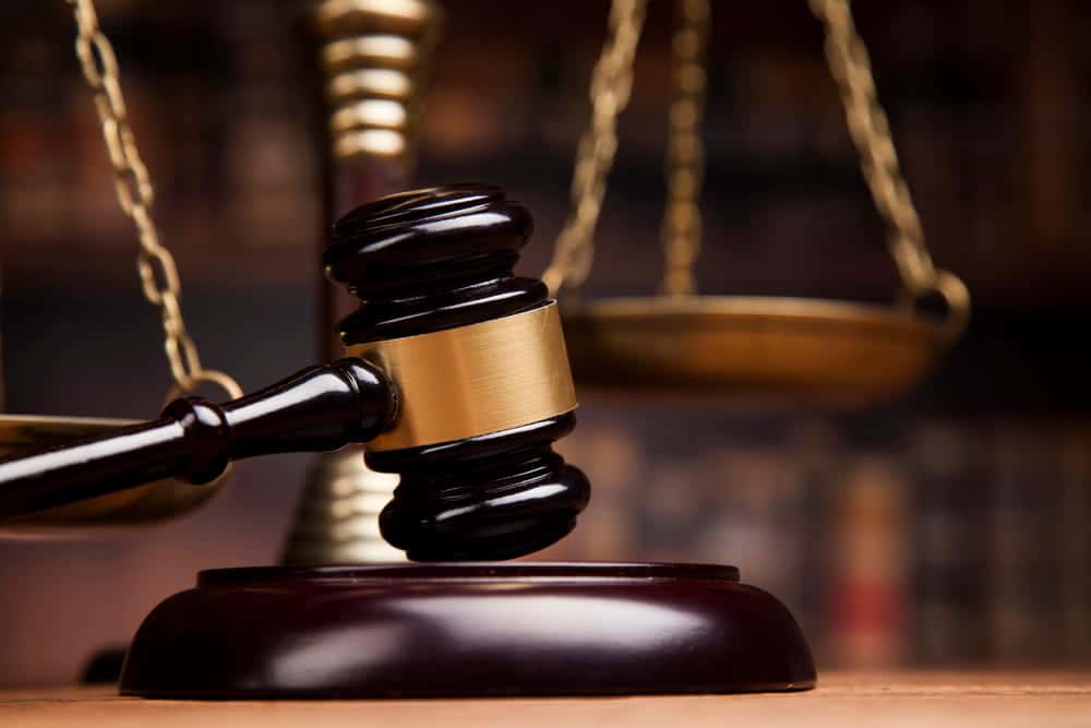 Image is of a judge's gavel and scales of justice, concept of court proceedings in a truck accident lawsuit in Nashville.