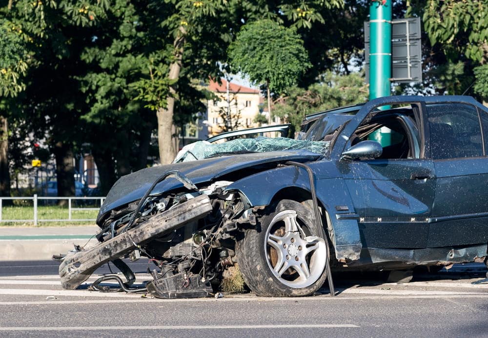Image is of a severely damaged vehicle at a crash scene, concept of a fatal car accident in Nashville.