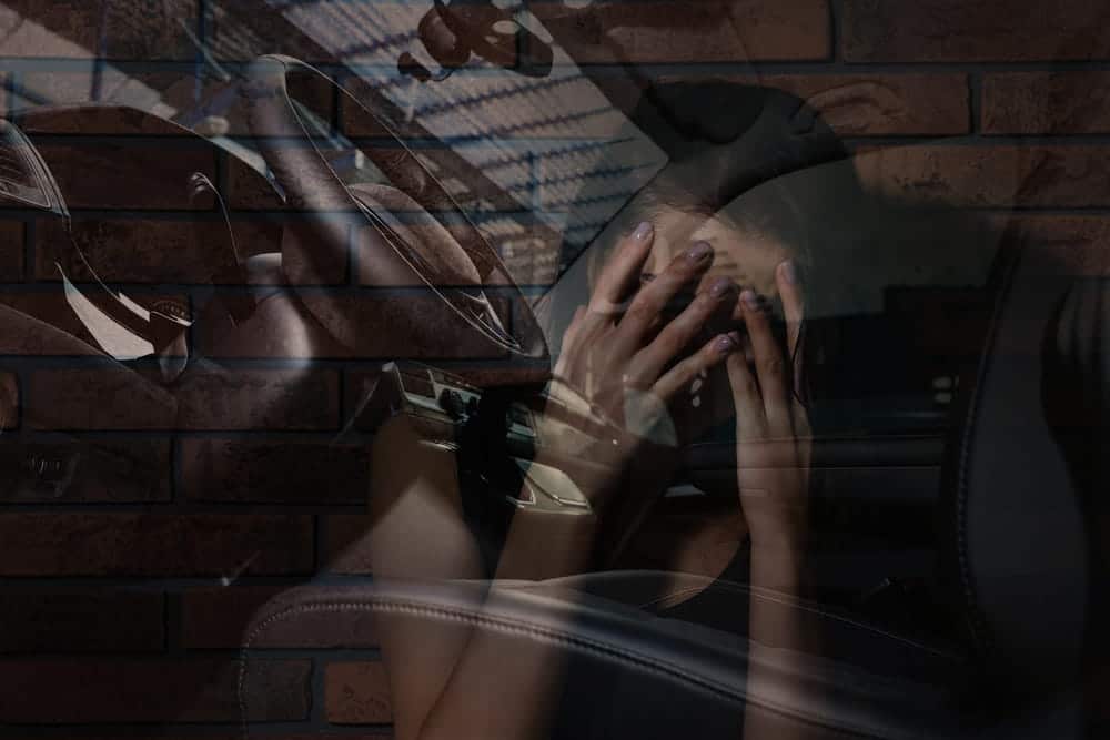 Image is of a grieving woman sitting inside a vehicle, concept of family loss after a fatal car accident in Nashville.