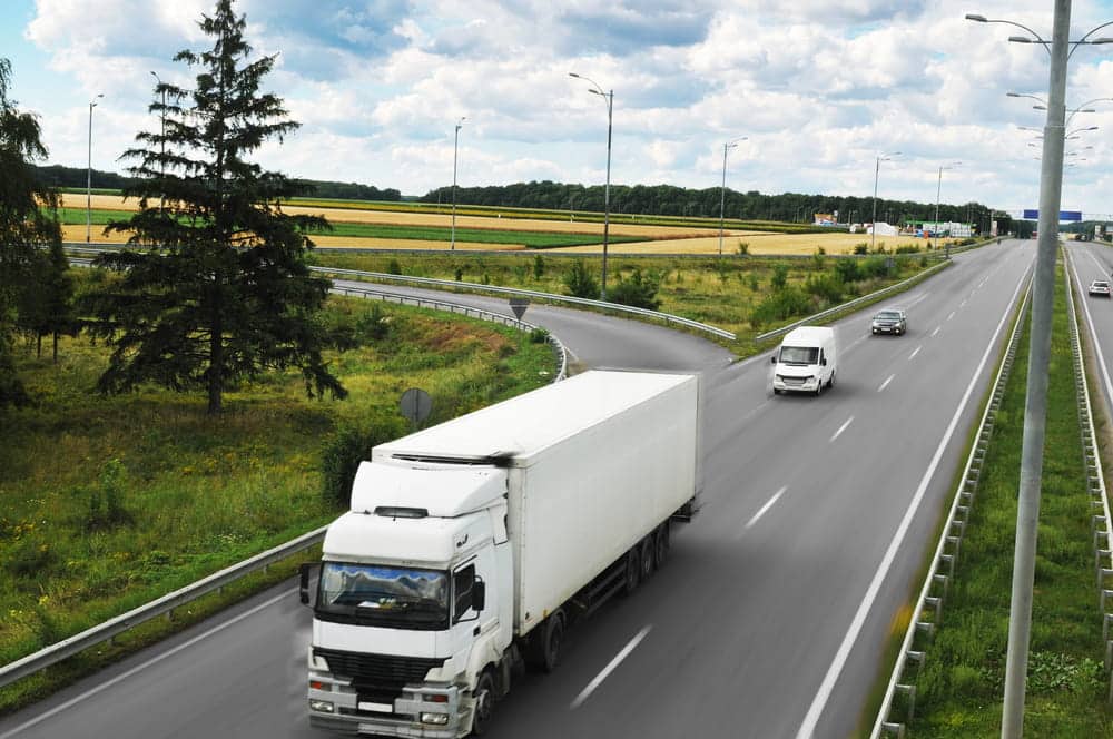 Image is of a semi truck traveling on a highway, concept of semi-truck blind spot awareness for Nashville drivers.