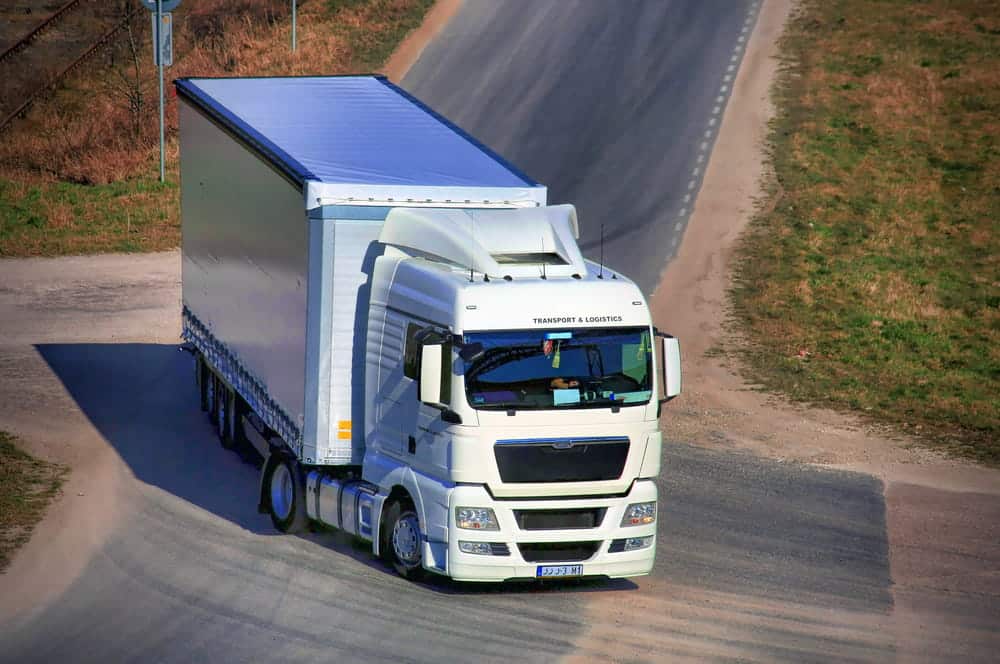 Image is of a large commercial truck traveling on a roadway, concept of vehicle size and truck crashes in Nashville.